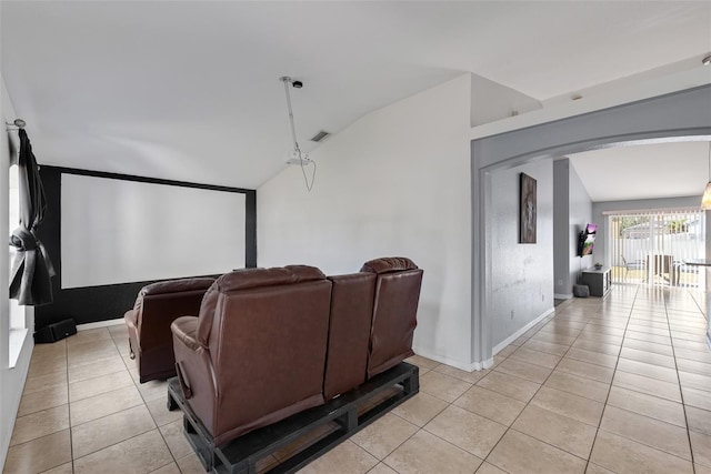 cinema featuring vaulted ceiling and light tile patterned flooring