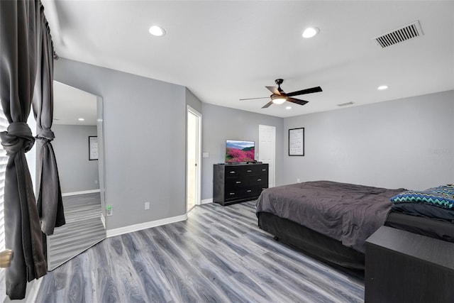 bedroom with ceiling fan and light hardwood / wood-style floors