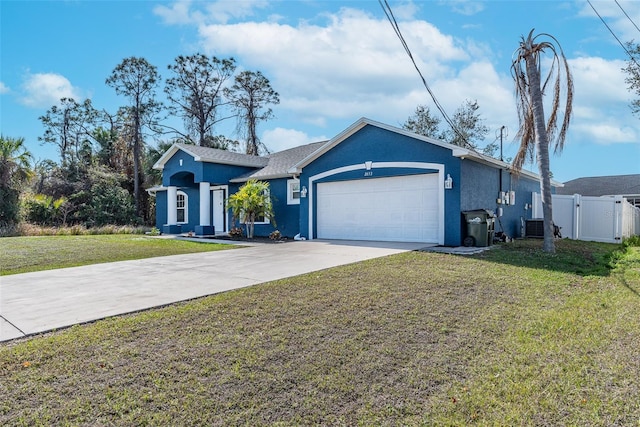 ranch-style house featuring cooling unit, a garage, and a front yard