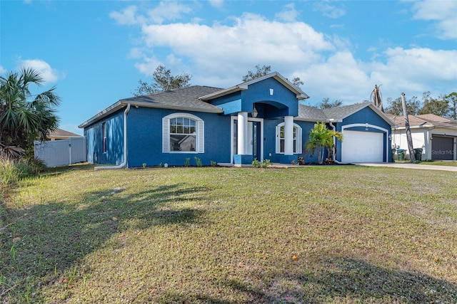 view of front of property with a garage and a front yard