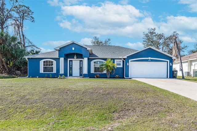 single story home with a garage and a front lawn