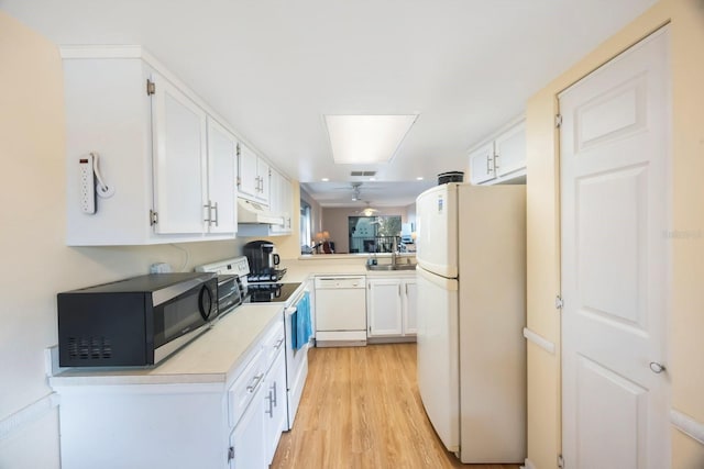 kitchen featuring sink, white cabinets, white appliances, and light hardwood / wood-style flooring