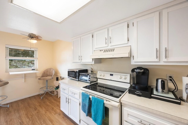 kitchen featuring white cabinetry, ceiling fan, light hardwood / wood-style flooring, and white range with electric stovetop