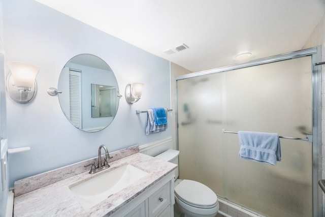 bathroom with vanity, toilet, and an enclosed shower