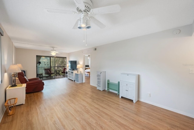 living room with light hardwood / wood-style floors and ceiling fan