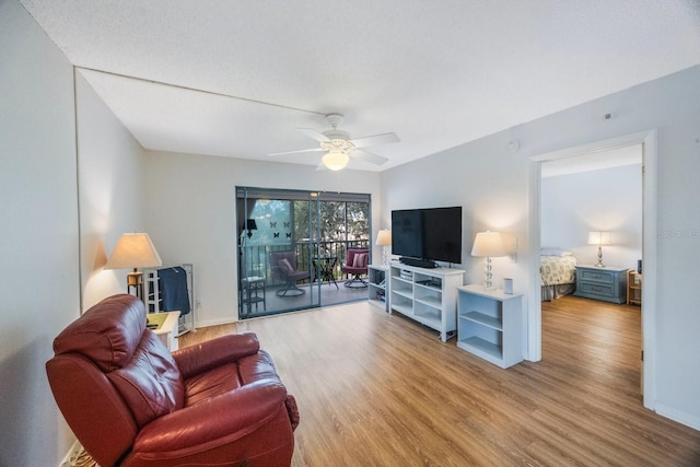 living room with ceiling fan and light wood-type flooring