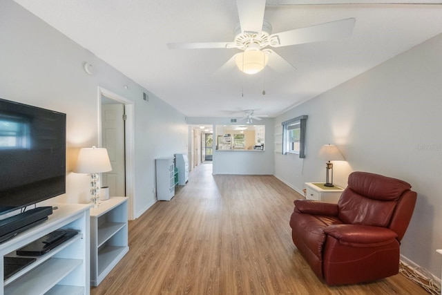 sitting room with light hardwood / wood-style flooring and ceiling fan