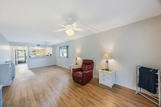 sitting room featuring light hardwood / wood-style floors and ceiling fan