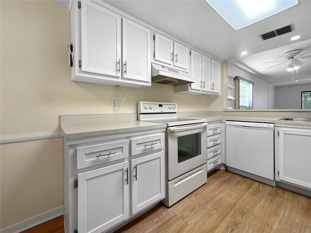 11485 Oakhurst Rd Unit A301, Largo, FL 33774 - kitchen featuring white appliances, under cabinet range hood, light wood-style flooring, and light countertops