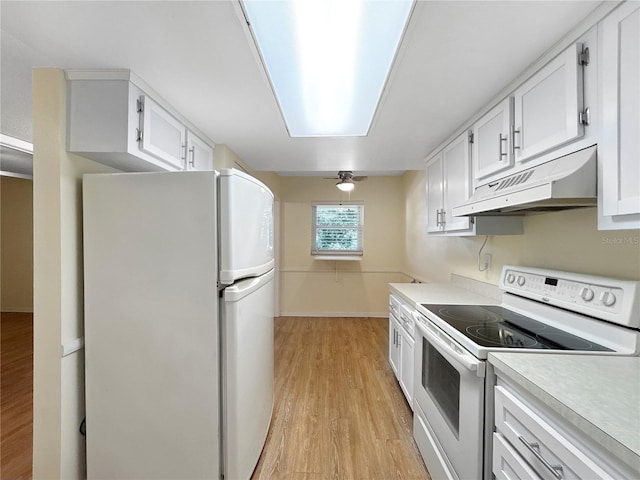 11485 Oakhurst Rd Unit A301, Largo, FL 33774 - kitchen with white appliances, under cabinet range hood, light wood-style floors, light countertops, and white cabinets