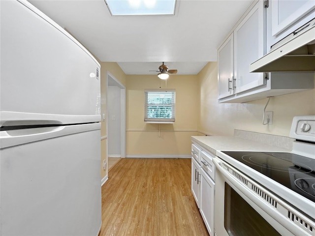 11485 Oakhurst Rd Unit A301, Largo, FL 33774 - kitchen featuring white appliances, under cabinet range hood, light wood finished floors, white cabinetry, and ceiling fan