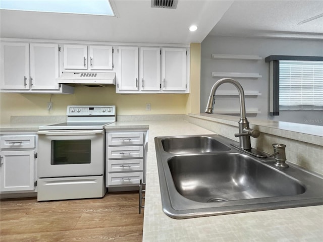 11485 Oakhurst Rd Unit A301, Largo, FL 33774 - kitchen featuring white electric range, under cabinet range hood, white cabinetry, light countertops, and recessed lighting