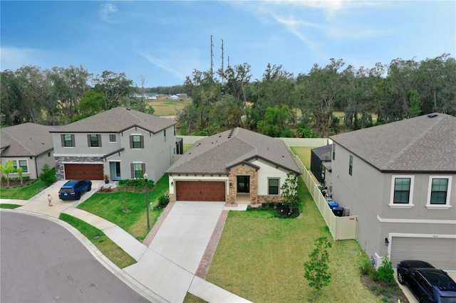 view of front of home featuring a residential view, concrete driveway, and a front yard