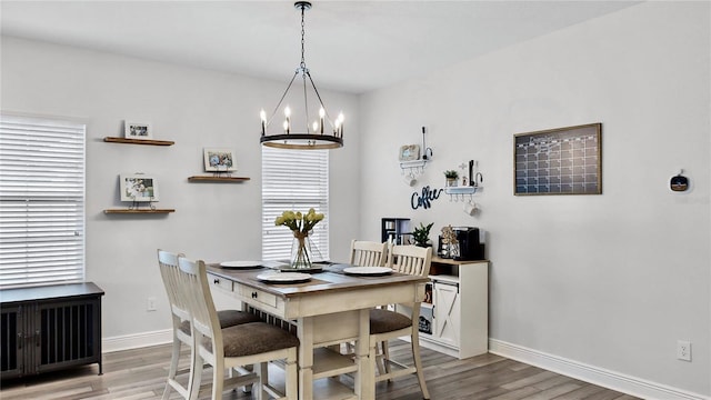 dining space with an inviting chandelier and hardwood / wood-style floors