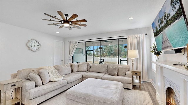 living room featuring ceiling fan and light wood-type flooring