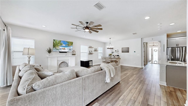 living room featuring plenty of natural light, hardwood / wood-style floors, and a fireplace