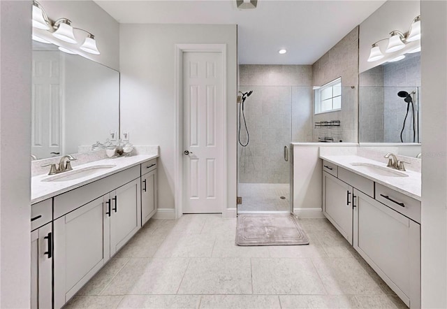 bathroom featuring tile patterned floors, vanity, and a shower with door