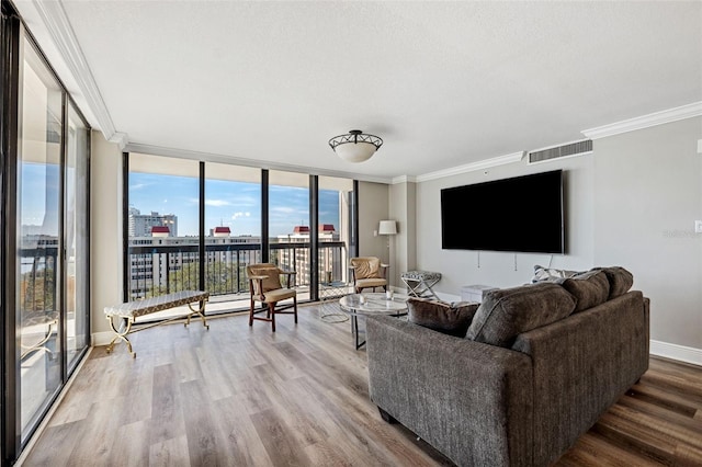 living room featuring ornamental molding, floor to ceiling windows, hardwood / wood-style floors, and a textured ceiling