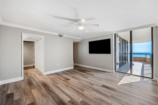 unfurnished room with crown molding, ceiling fan, and light hardwood / wood-style floors