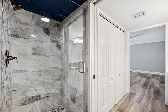 bathroom featuring wood-type flooring and walk in shower