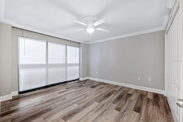 spare room with crown molding, hardwood / wood-style floors, and ceiling fan