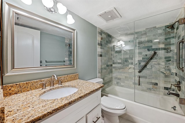 full bathroom with vanity, shower / bath combination with glass door, and toilet