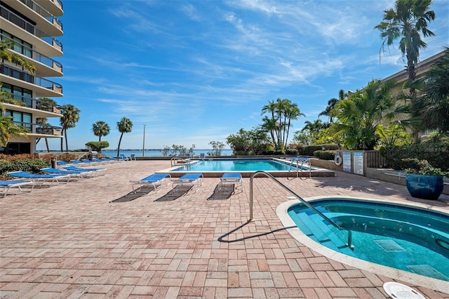 view of swimming pool with a water view