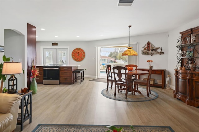 dining room featuring light hardwood / wood-style floors and french doors