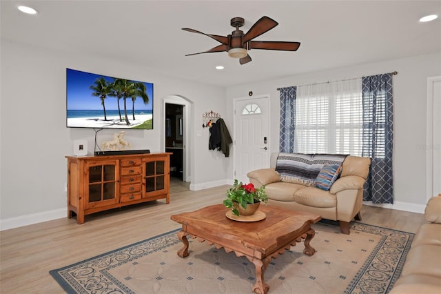 living room with ceiling fan and light hardwood / wood-style floors