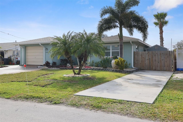 single story home featuring a garage and a front lawn