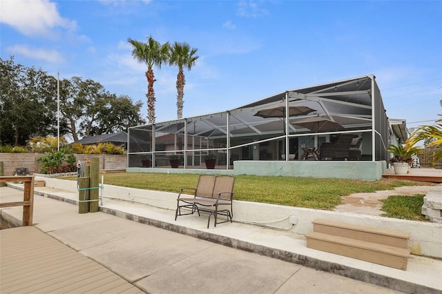 view of property's community featuring a lawn and a patio area