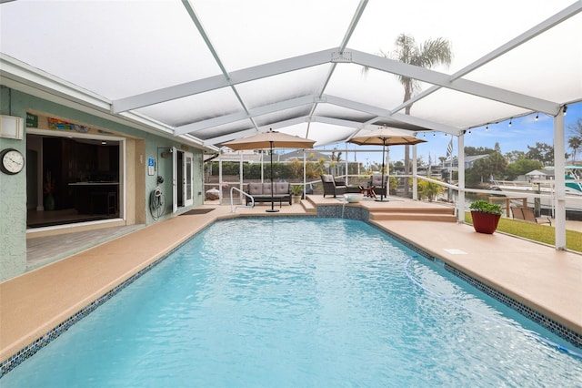 view of pool with a patio and glass enclosure