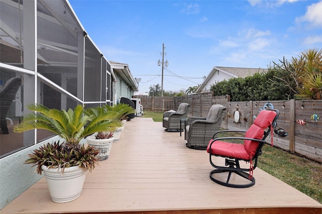 wooden terrace featuring an outdoor living space and a lanai