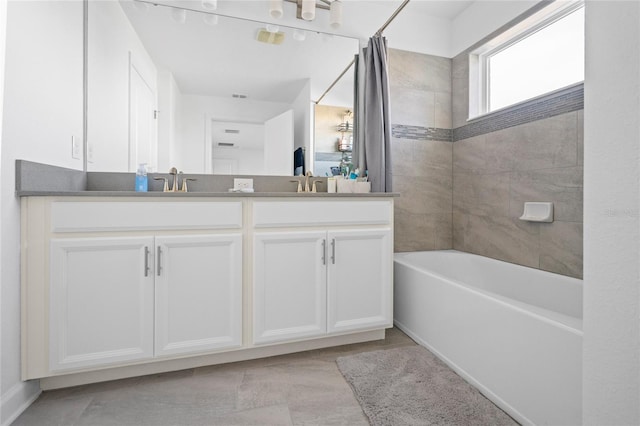 bathroom featuring vanity and shower / bath combination with curtain