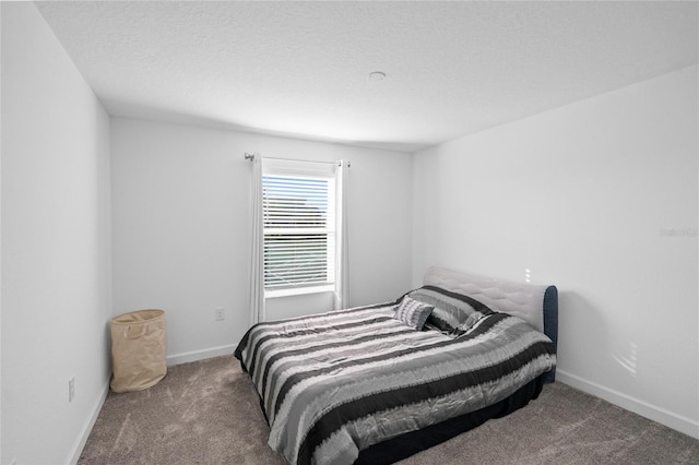 bedroom featuring carpet flooring and a textured ceiling