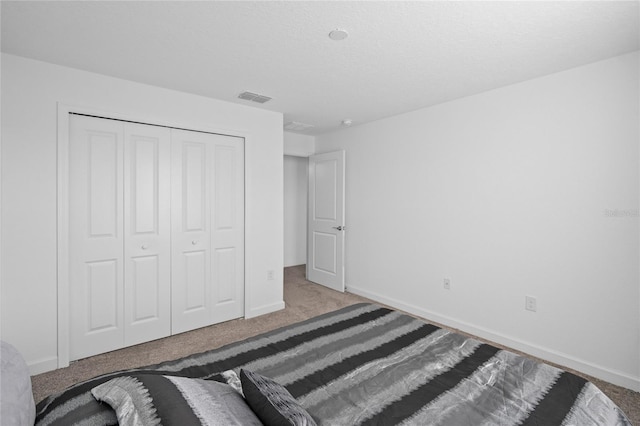 unfurnished bedroom with a closet and light carpet