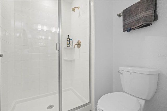 bathroom with an enclosed shower and toilet