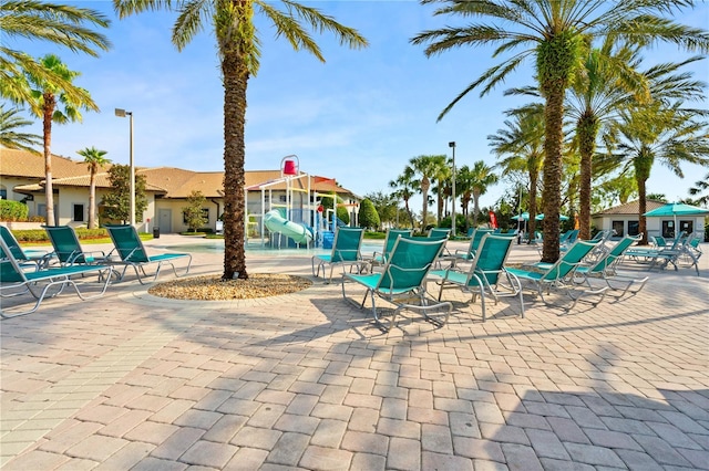 view of swimming pool featuring a playground