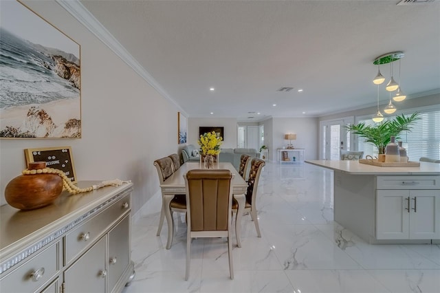 dining room with ornamental molding and a textured ceiling