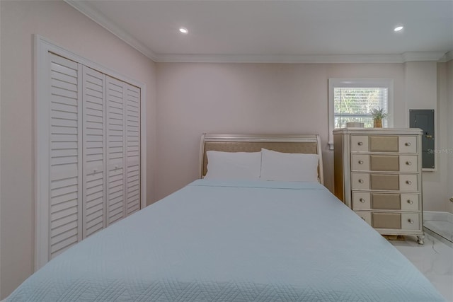 bedroom with crown molding and a closet