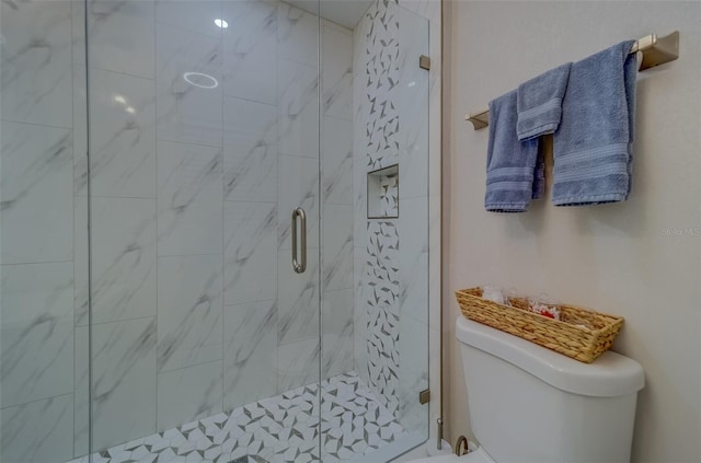 bathroom featuring walk in shower and toilet