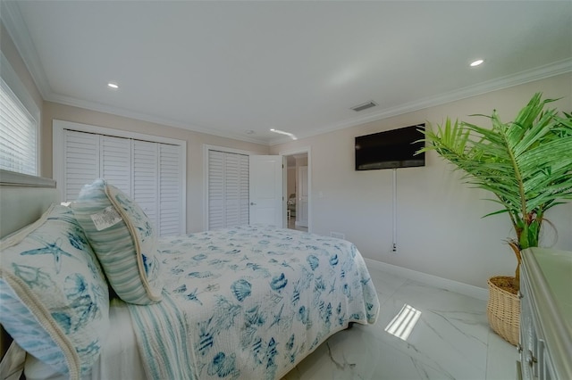 bedroom with crown molding and two closets