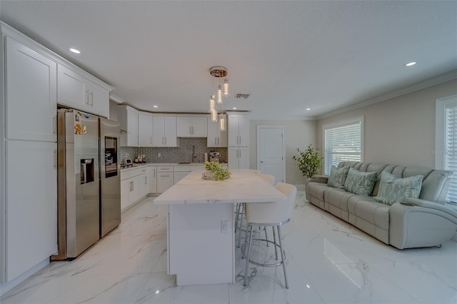 kitchen featuring white cabinetry, decorative light fixtures, crown molding, and stainless steel fridge with ice dispenser