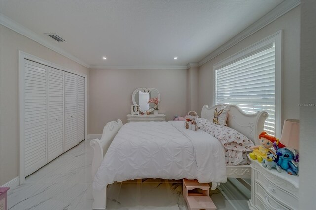 bedroom with crown molding and a closet