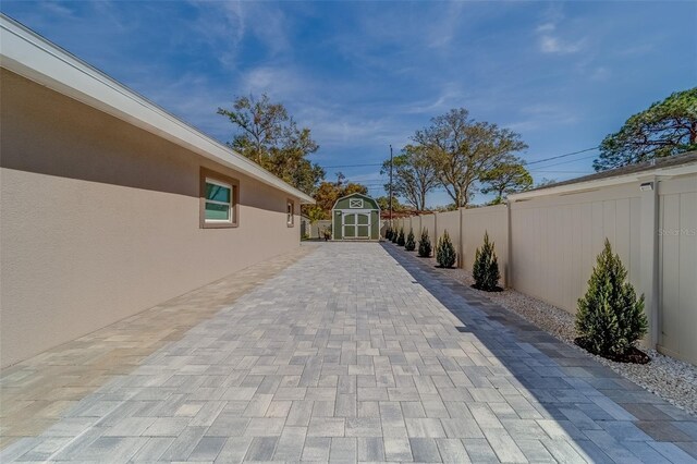 view of patio featuring a storage shed