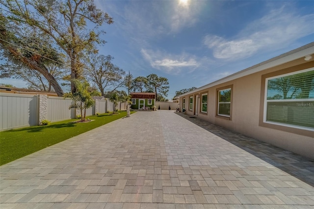 exterior space featuring a patio and an outdoor structure