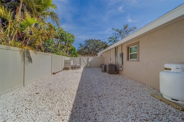 view of yard with central AC unit and a patio area