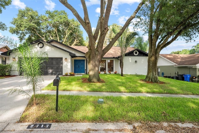 single story home with a garage and a front yard