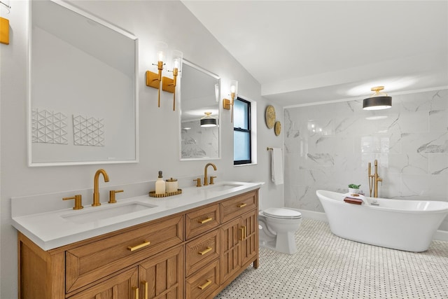 bathroom with vanity, toilet, tile walls, and a washtub