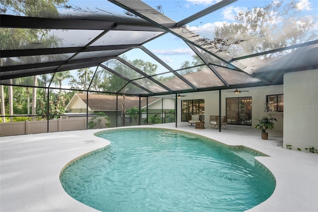 view of pool with ceiling fan, a lanai, and a patio